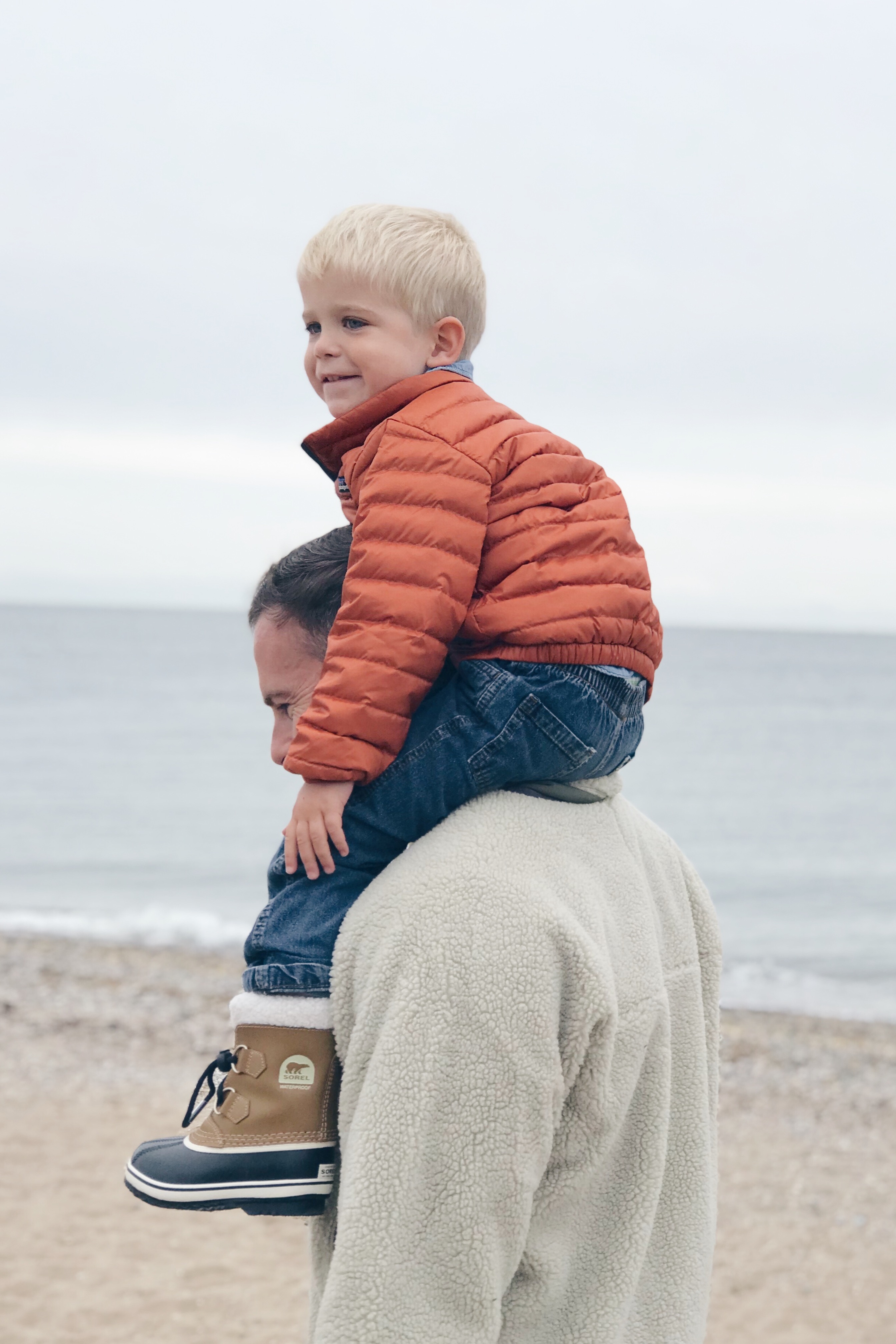 Fall bucket list for families - toddler boy in orange Patagonia puffer jacket