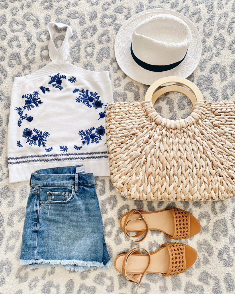 blue embroidered sweater halter tank flatlay with large summer straw tote
