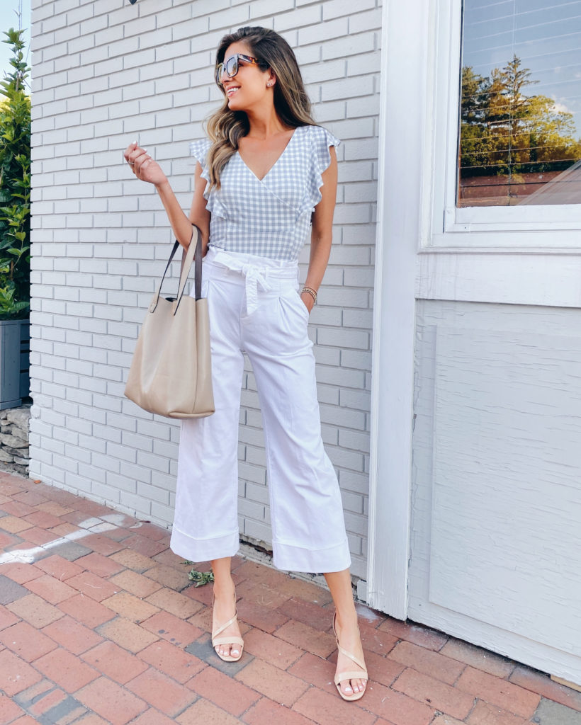 flutter sleeve gingham print top with white tie waist wide leg jeans for summer evening outfit