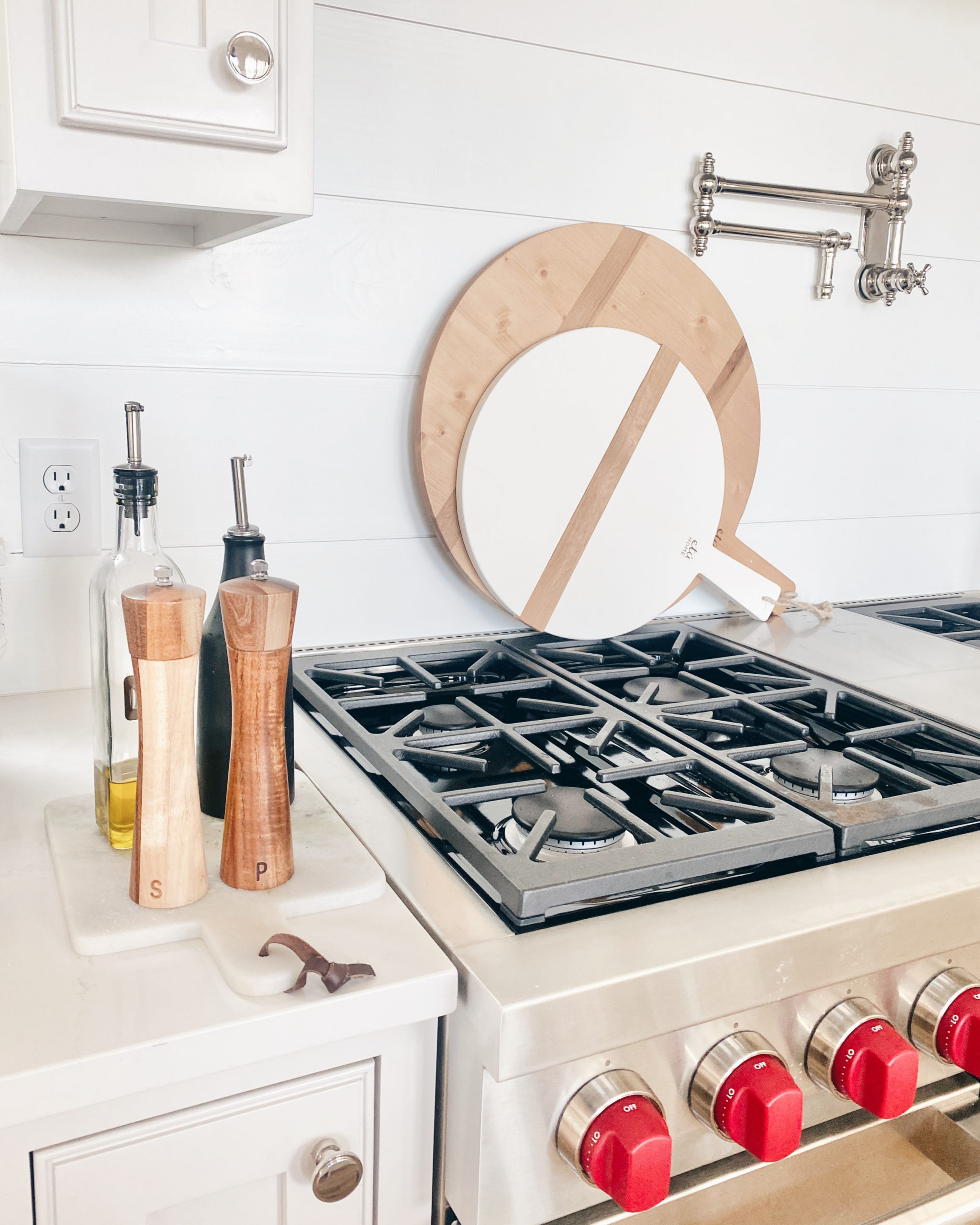 round serving boards on wolf stove kitchen backsplash